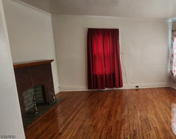 a view of a room with wooden floor and stairs