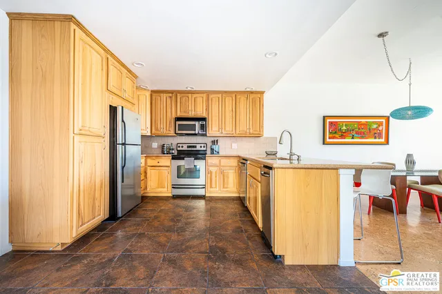 a kitchen with stainless steel appliances a refrigerator sink and cabinets