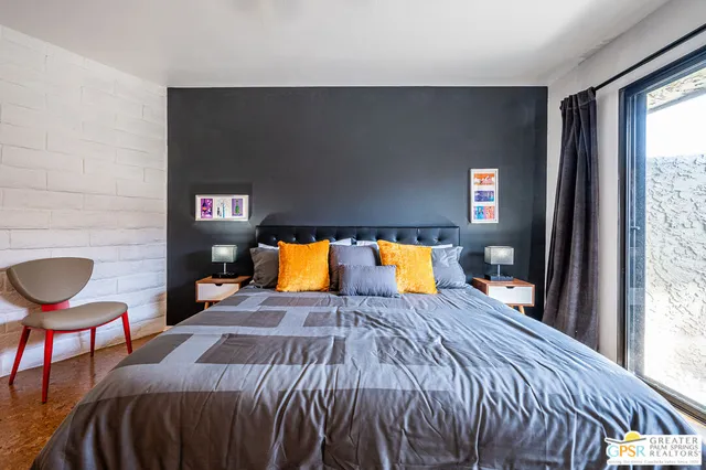 a bed sitting in a bedroom next to a window