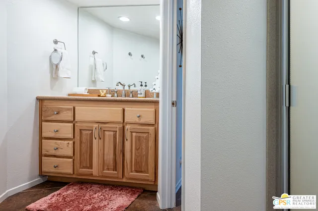 a bathroom with a sink a vanity and a mirror