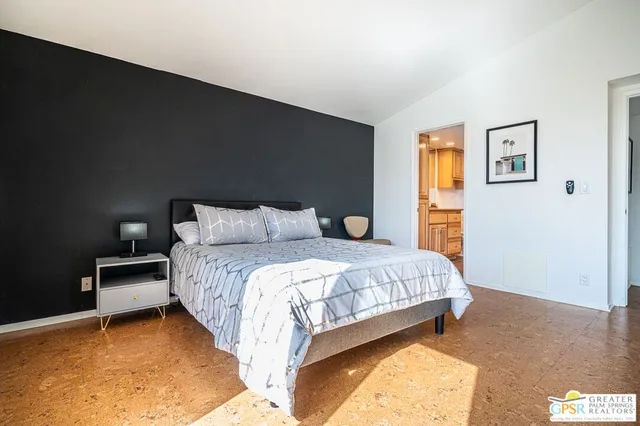 a bedroom with a bed and a table