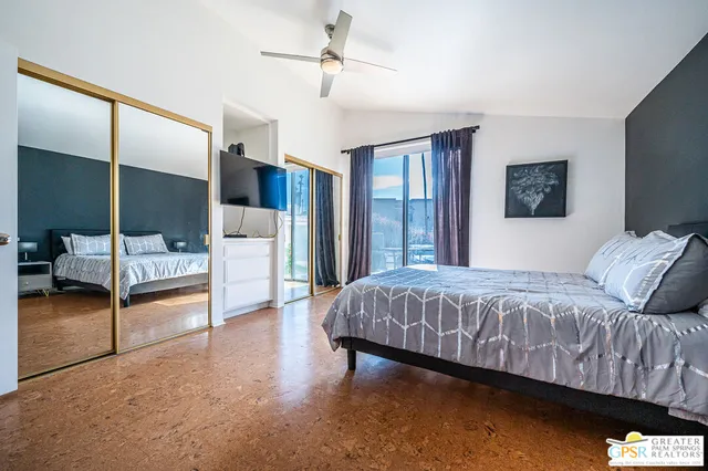 a bedroom with a bed a table and painting