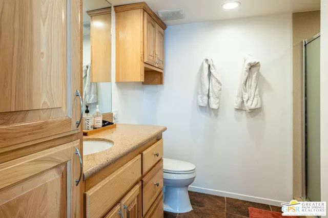 a bathroom with a sink and mirror with toilet