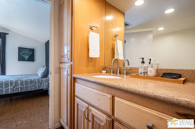 a en suite bathroom with a sink and a mirror
