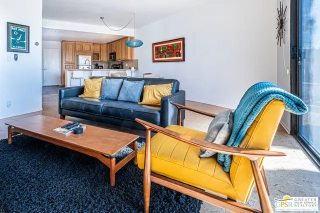 a living room with furniture and next to a window