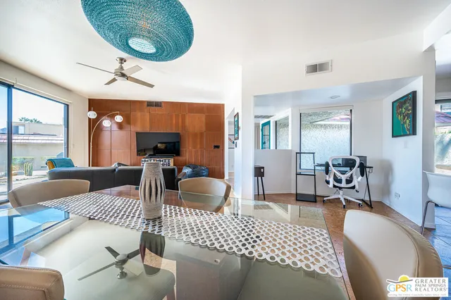 a living room with furniture a rug and a chandelier