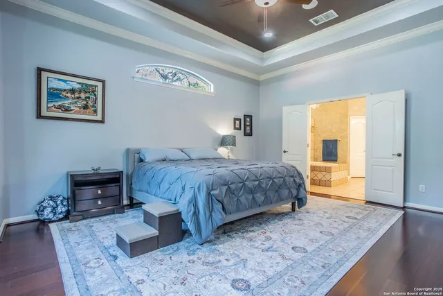 a bedroom with a large bed a rug and a window