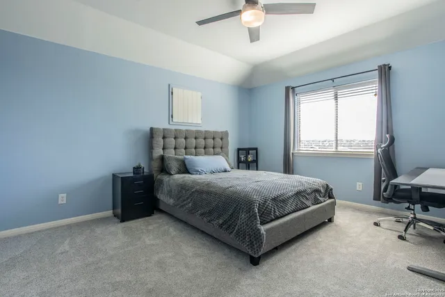 a spacious bedroom with a bed and a table in it