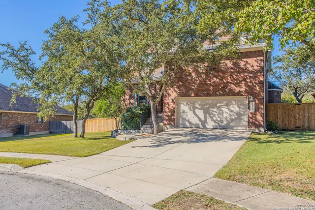 a view of a house with a yard and tree s