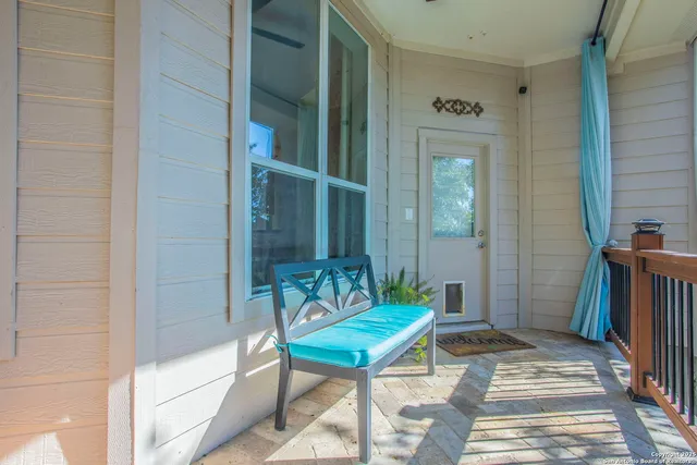 a backyard of a house with barbeque oven table and chairs