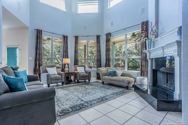 a living room with furniture and large windows