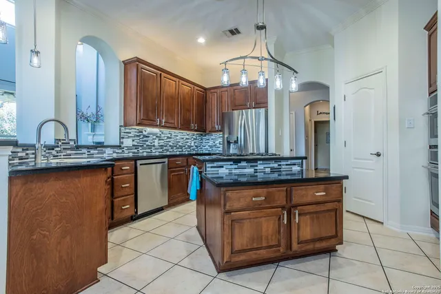 a kitchen with stainless steel appliances granite countertop a sink and cabinets