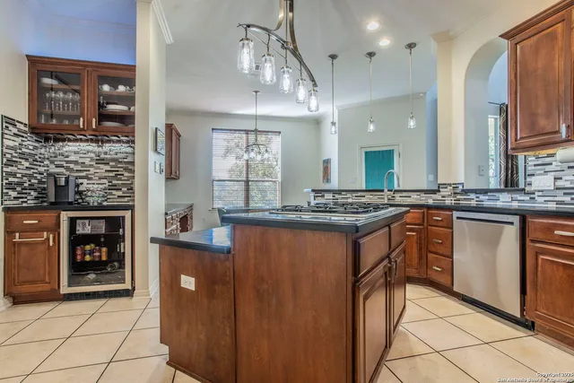 a kitchen with stainless steel appliances granite countertop a stove a sink and a refrigerator