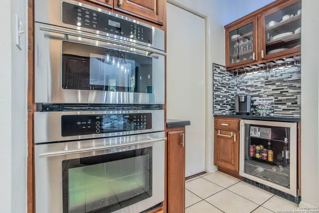 a stove top oven sitting inside of a kitchen