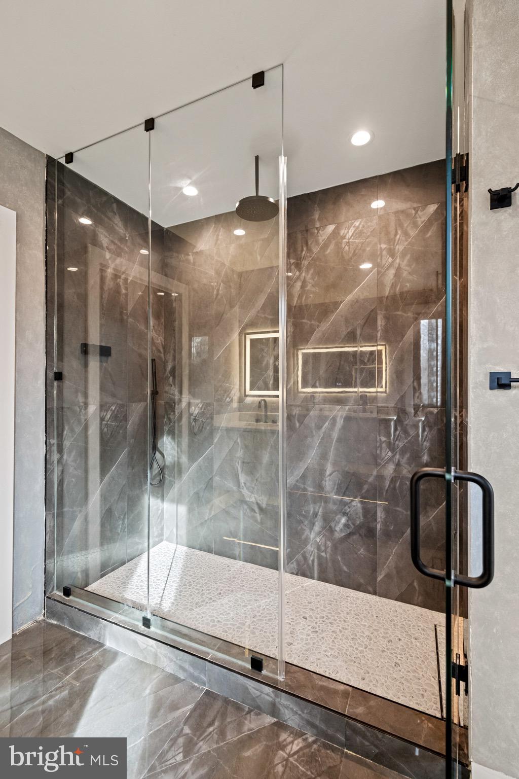 1573 Westmoreland Street McLean, VA 22101 - Photo 35 of 54 a bathroom with a shower and a glass door