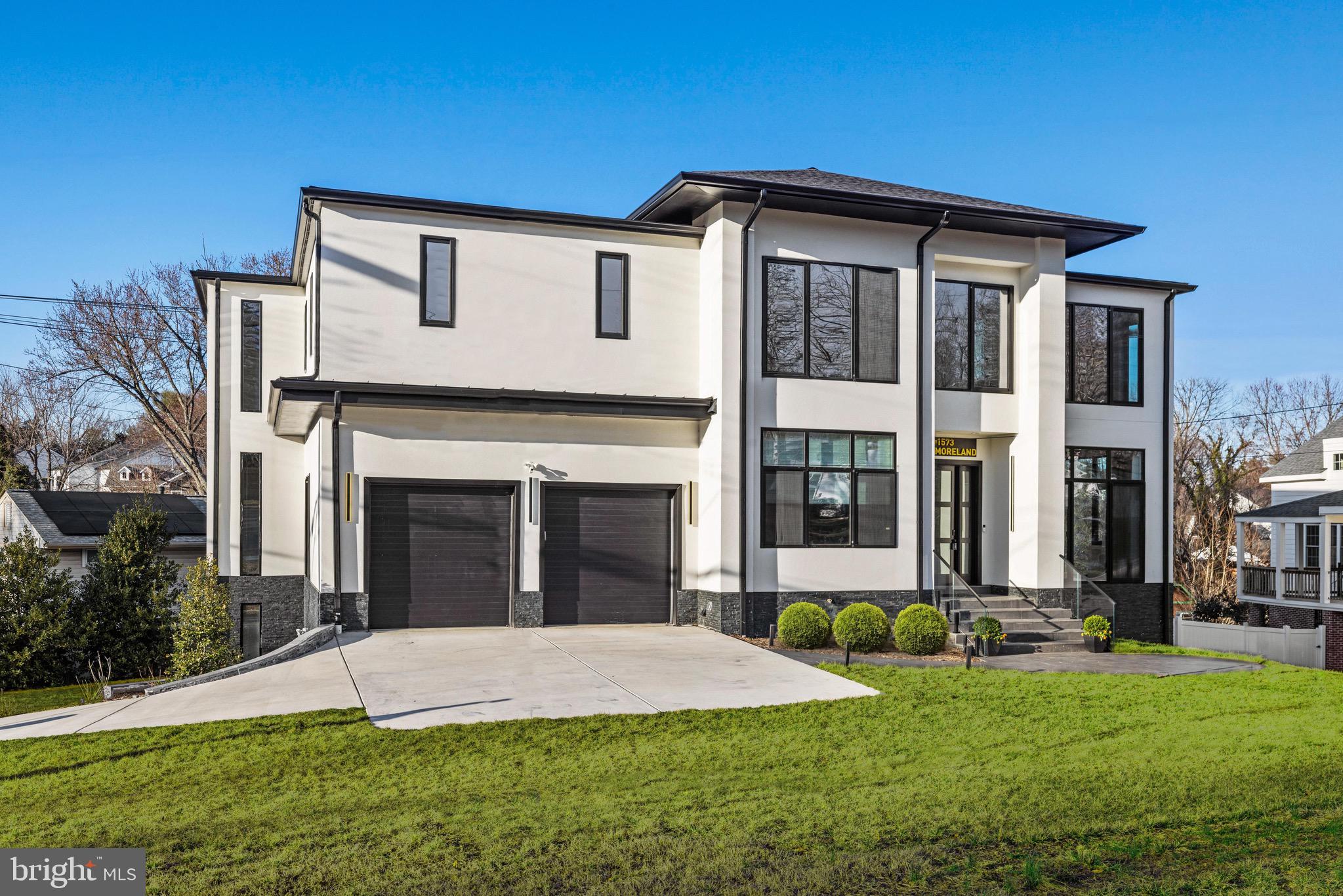 1573 Westmoreland Street McLean, VA 22101 - Photo 49 of 54 a front view of a house with a yard and garage