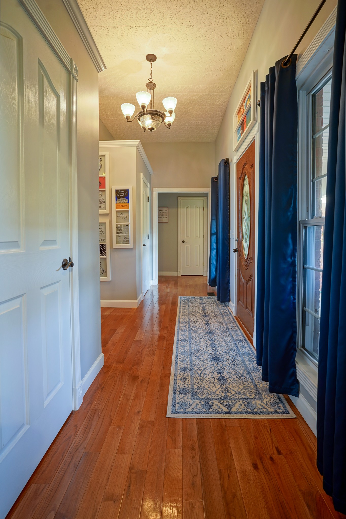 17 Marks Branch Road Leoma, TN 38468 - Photo 44 of 50 a view of a hallway with wooden floor and chandelier