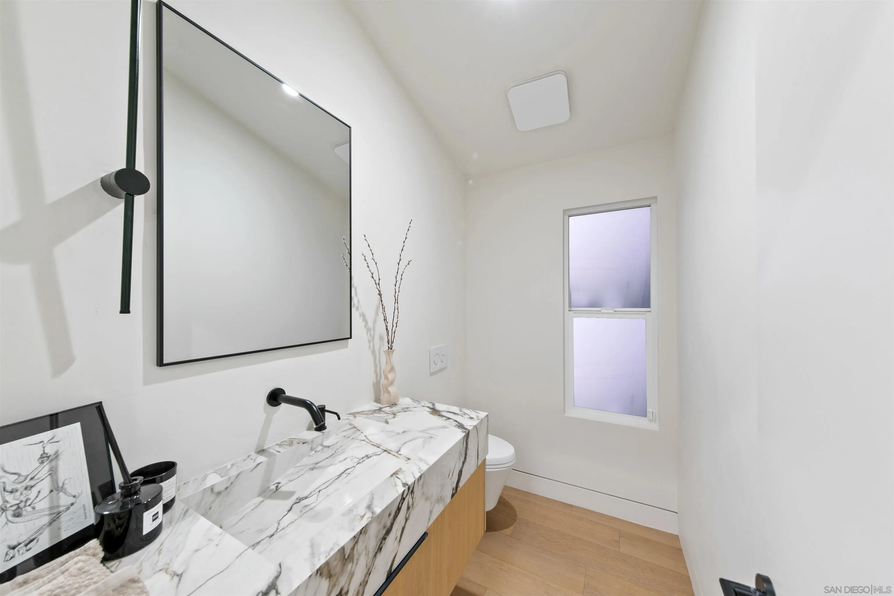 5675 Soledad Mountain Road La Jolla, CA 92037 - Photo 16 of 74 a bathroom with a sink and a mirror