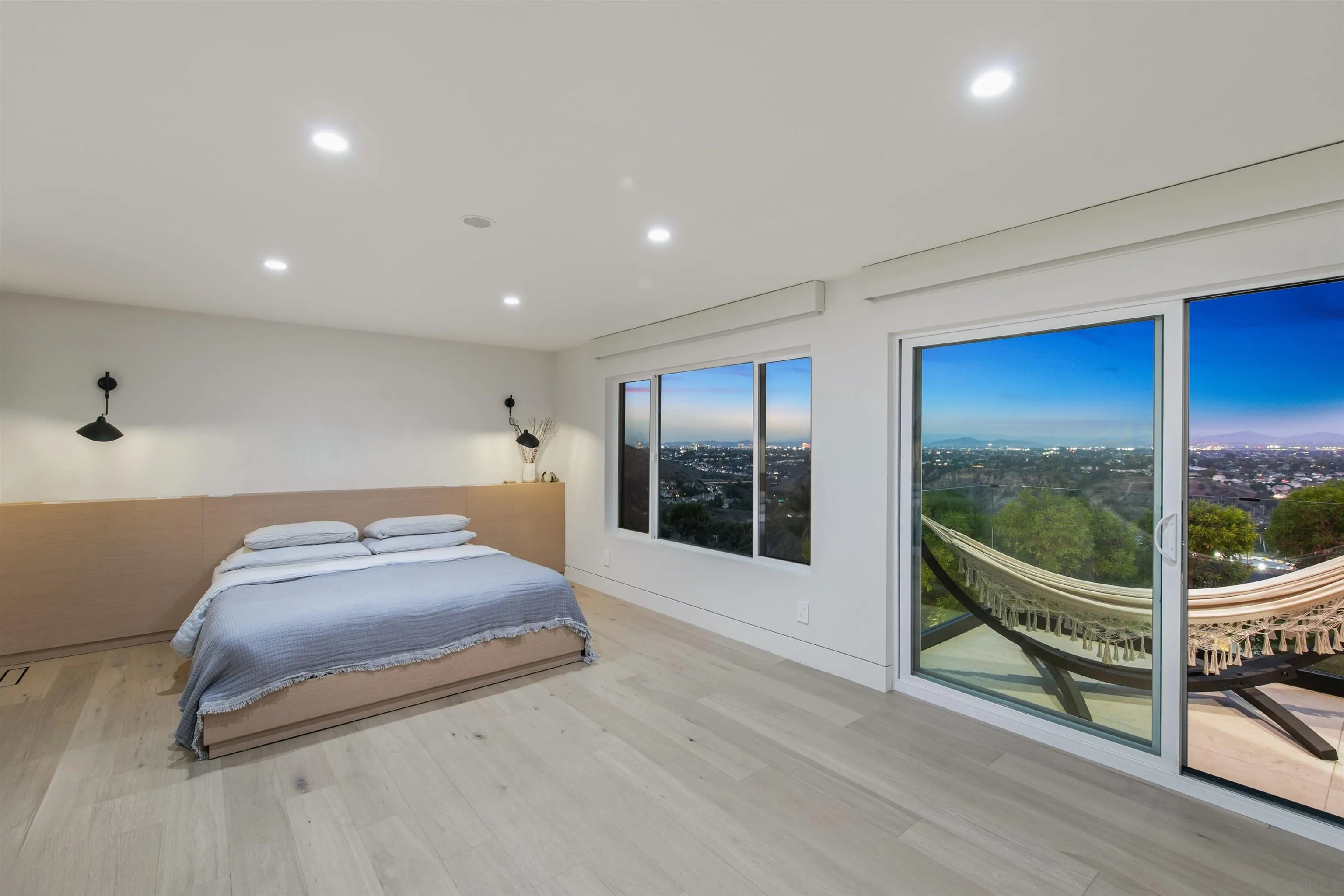 5675 Soledad Mountain Road La Jolla, CA 92037 - Photo 20 of 74 a bedroom with a bed and glass walk in closet