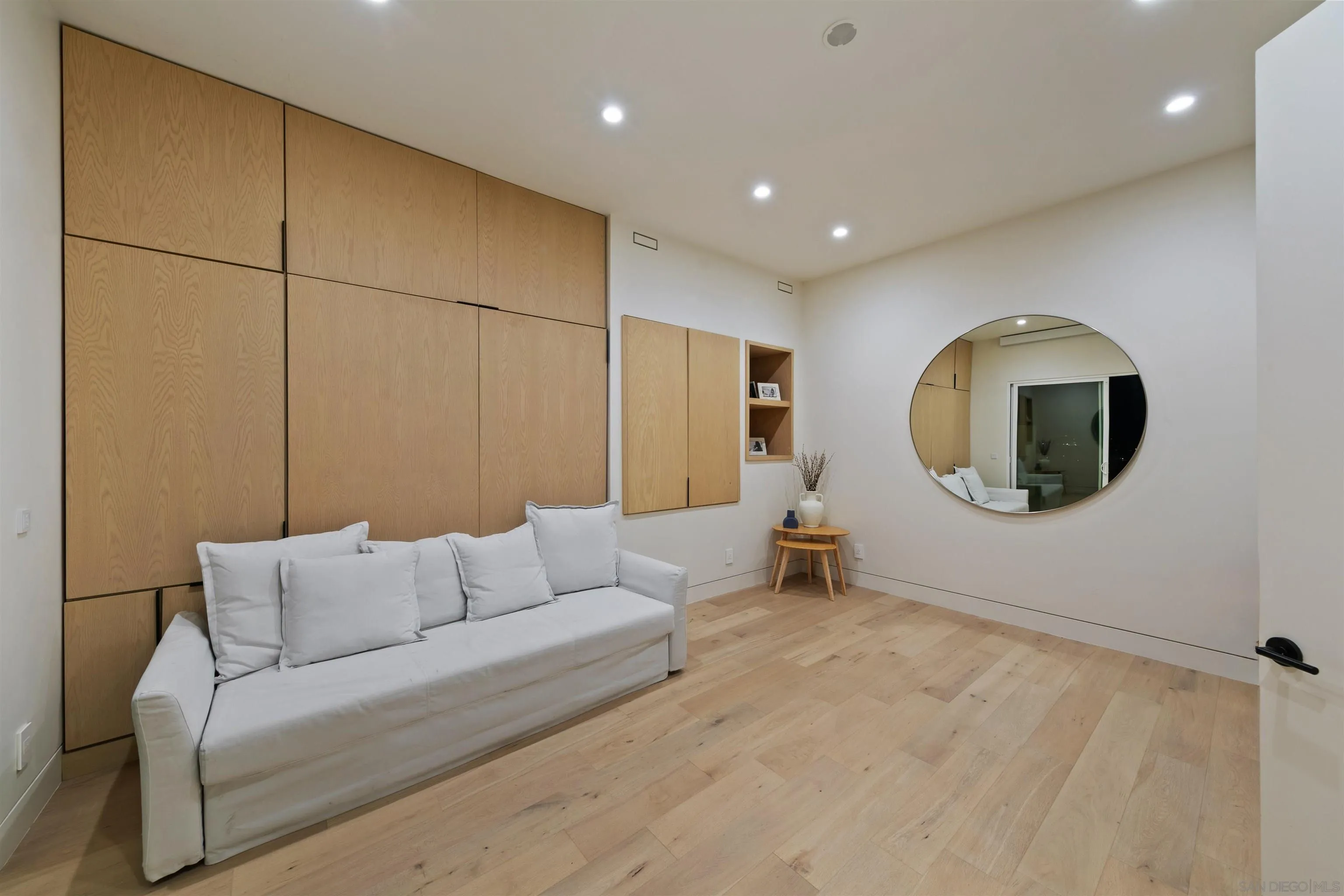 5675 Soledad Mountain Road La Jolla, CA 92037 - Photo 38 of 74 a living room with a couch and a mirror