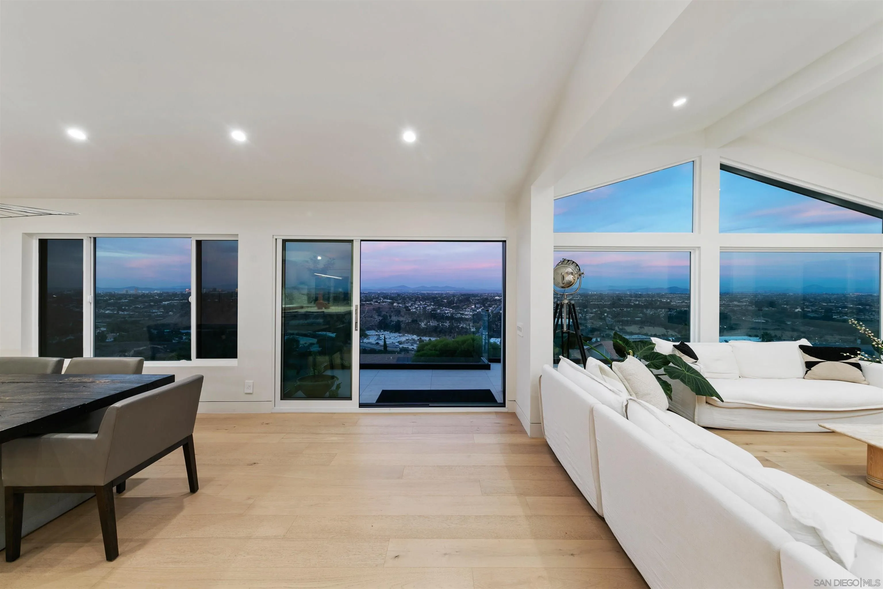 5675 Soledad Mountain Road La Jolla, CA 92037 - Photo 69 of 74 a living room with furniture floor to ceiling windows and a table