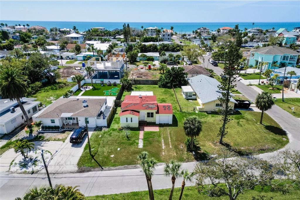 an aerial view of multiple houses with yard