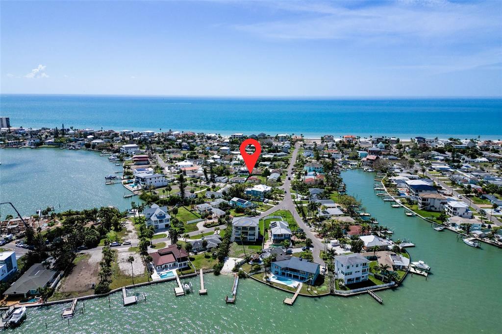 15822 Redington Drive Redington Beach, FL 33708 - Photo 2 of 11 an aerial view of a houses with a yard and lake view