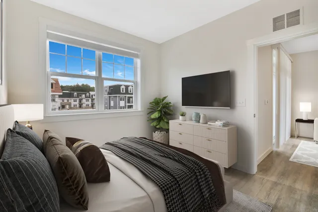 a bedroom with a bed and a flat screen tv
