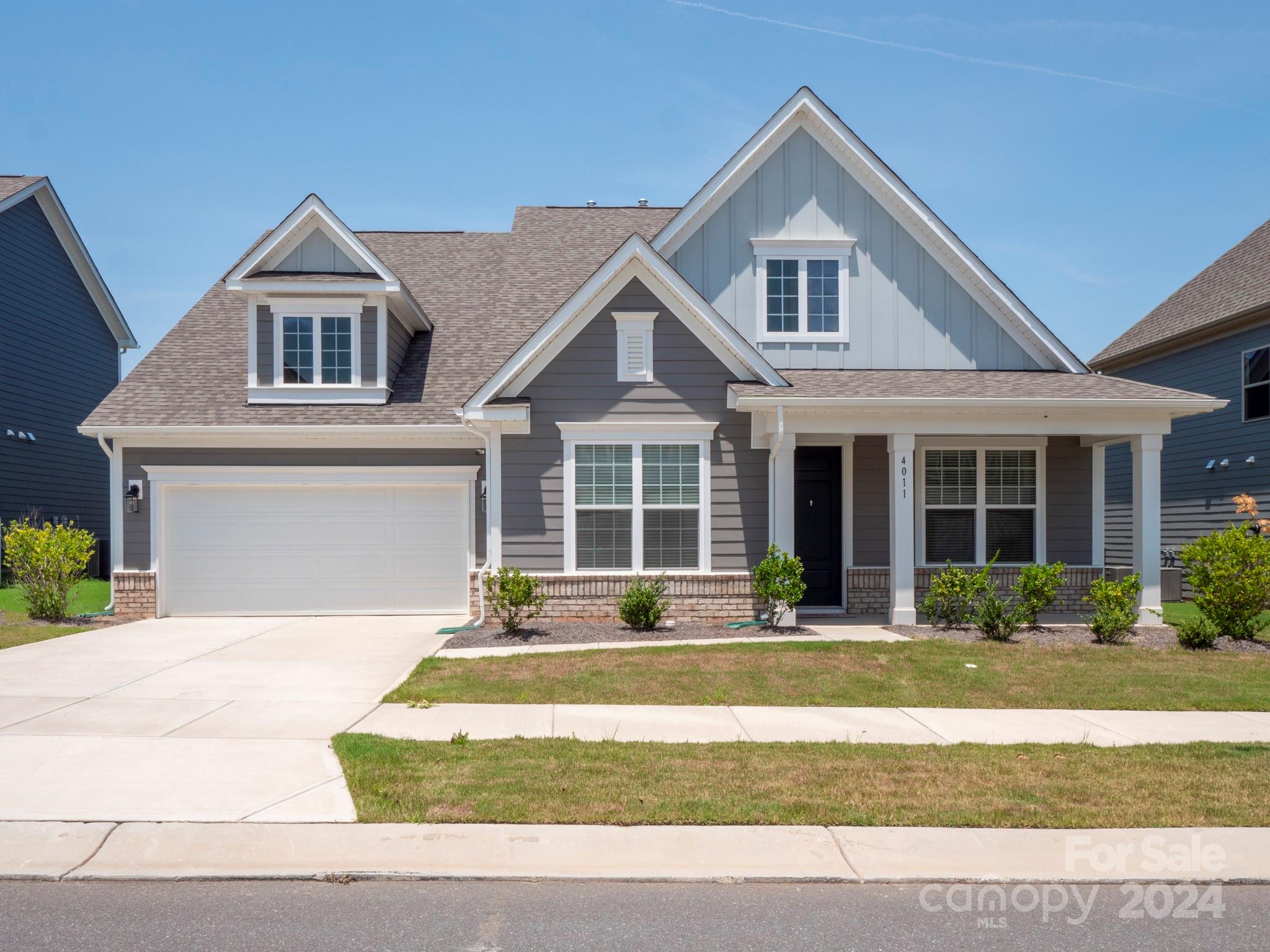 4011 Charlton Road Fort Mill, SC 29715 - Photo 1 of 48 a front view of a house with a yard and plants