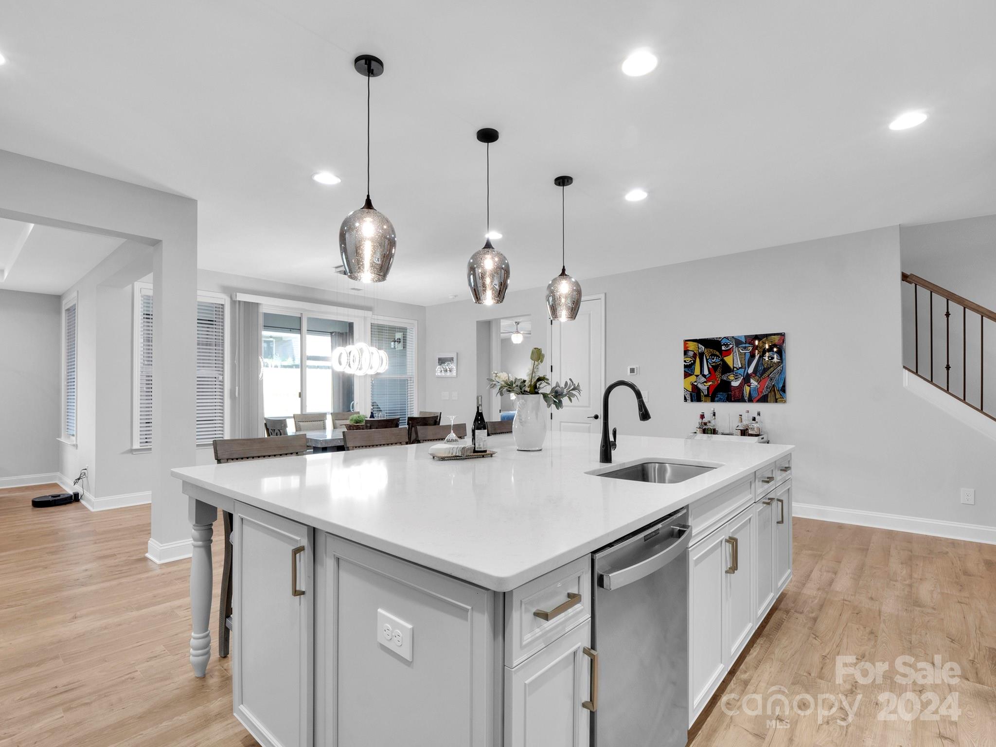 4011 Charlton Road Fort Mill, SC 29715 - Photo 16 of 48 a large kitchen with kitchen island a stove a sink a center island and wooden floor