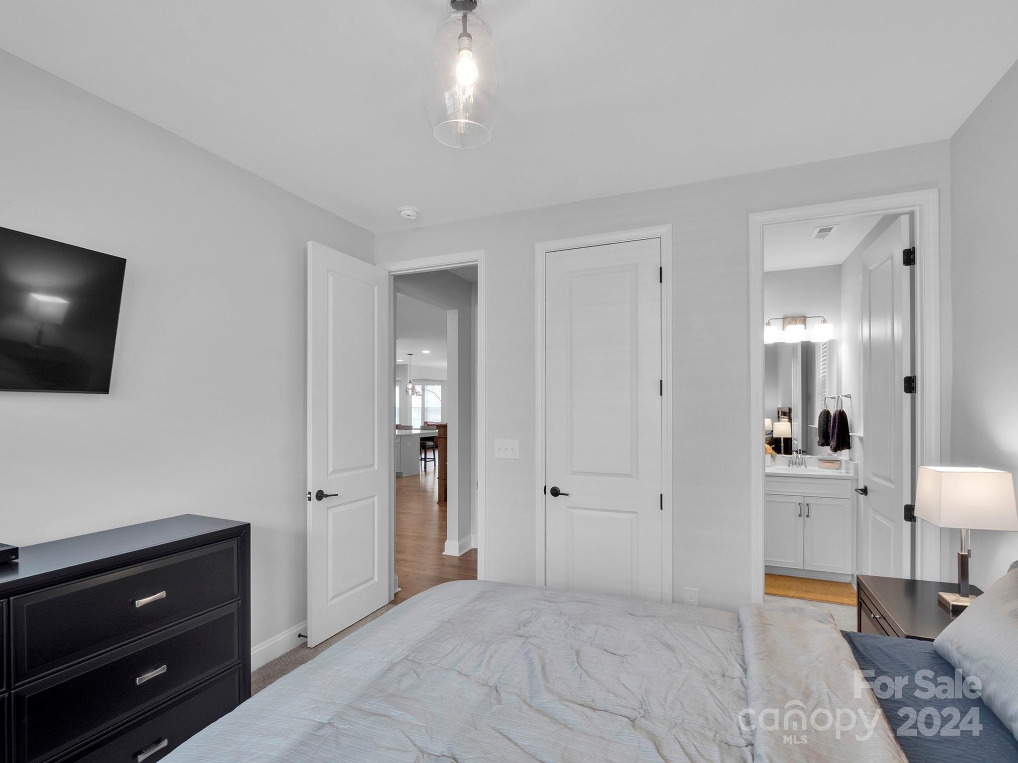 4011 Charlton Road Fort Mill, SC 29715 - Photo 22 of 48 a spacious bedroom with a bed and a flat screen tv