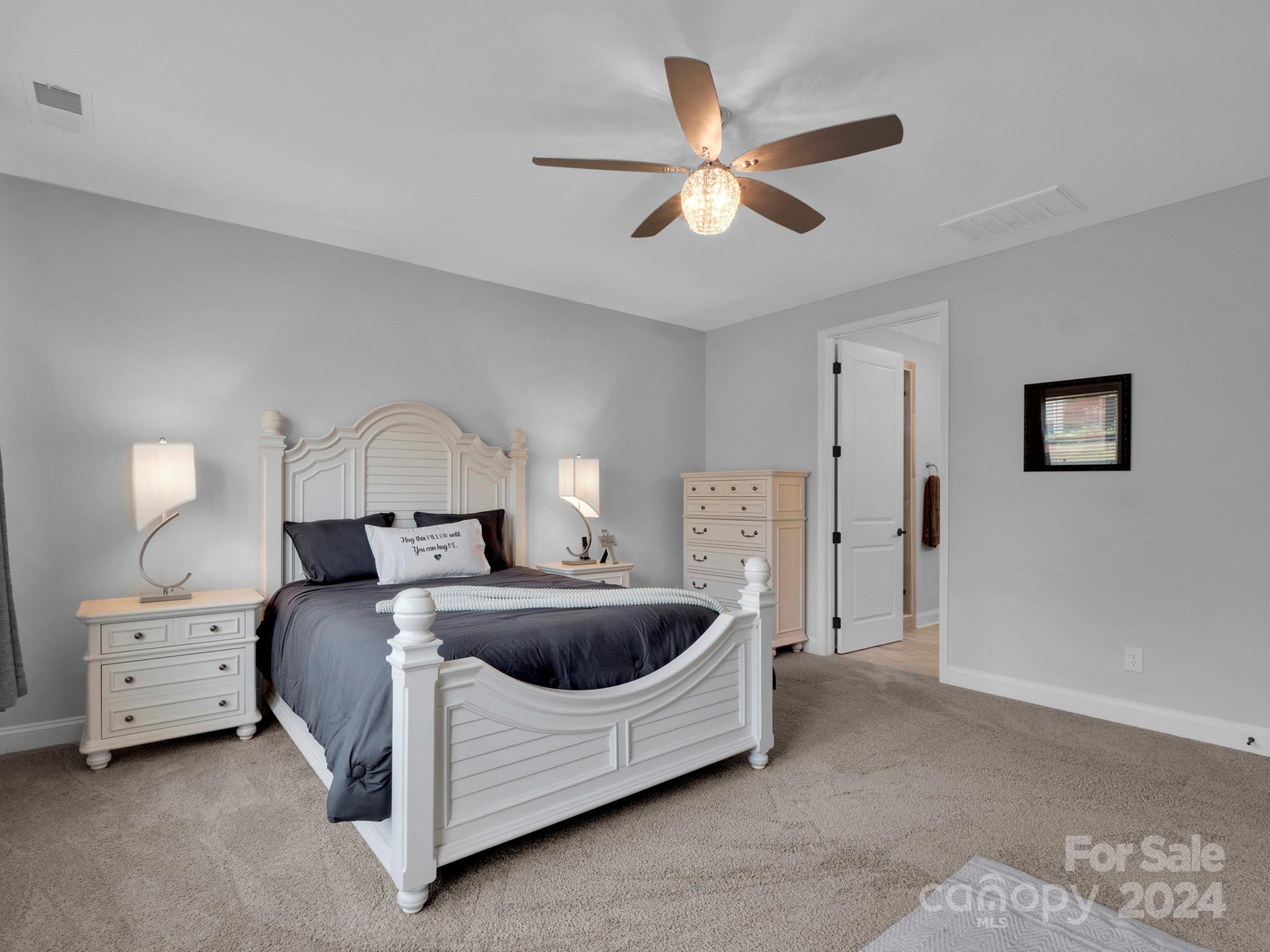 4011 Charlton Road Fort Mill, SC 29715 - Photo 30 of 48 a spacious bedroom with a bed and a chandelier