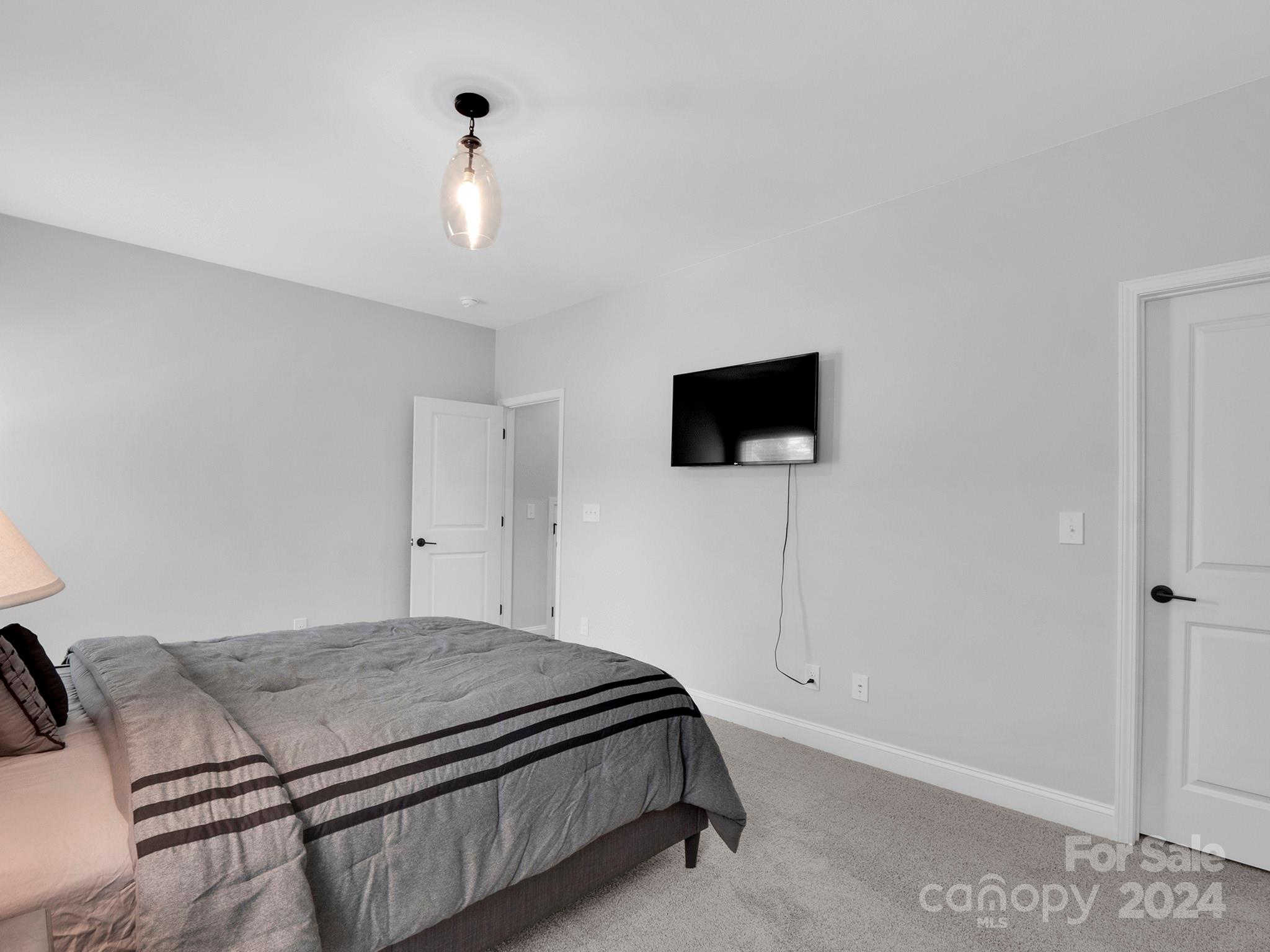 4011 Charlton Road Fort Mill, SC 29715 - Photo 42 of 48 a bedroom with a bed and a flat screen tv