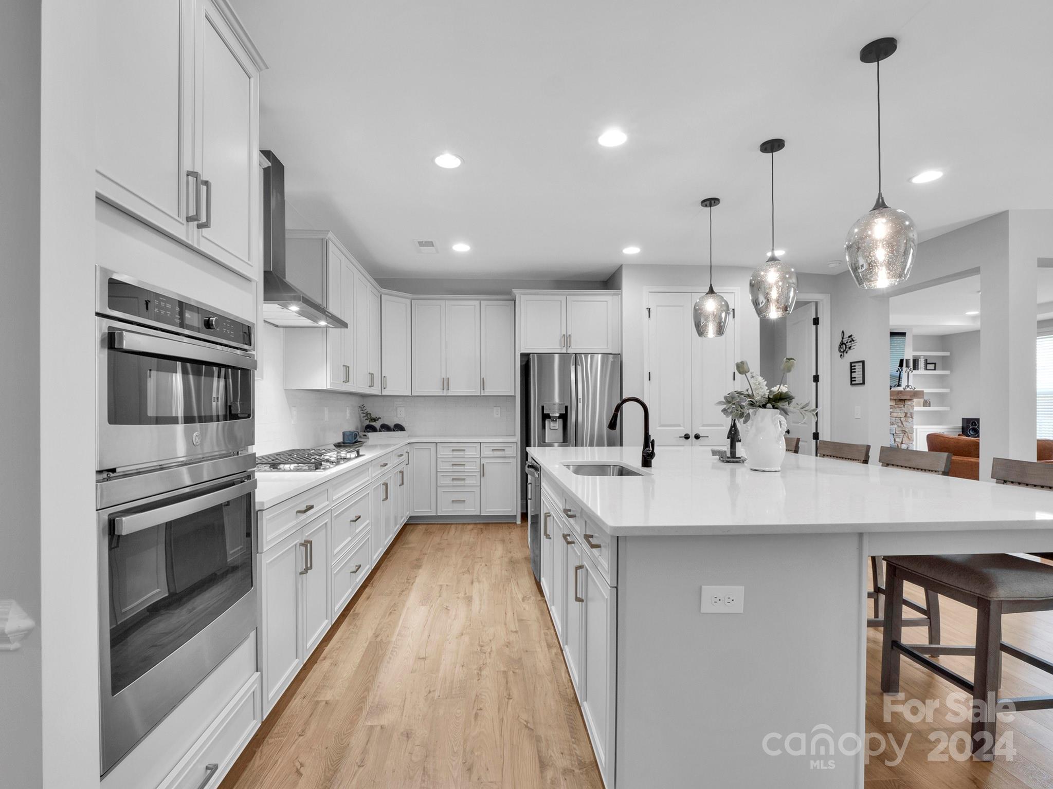 4011 Charlton Road Fort Mill, SC 29715 - Photo 6 of 48 a large kitchen with kitchen island a sink counter space stainless steel appliances and cabinets