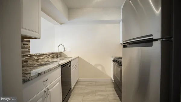a kitchen with a stove and a refrigerator