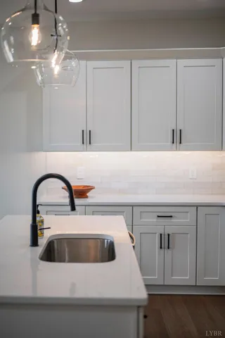 a close view of a sink a faucet and appliance in the kitchen