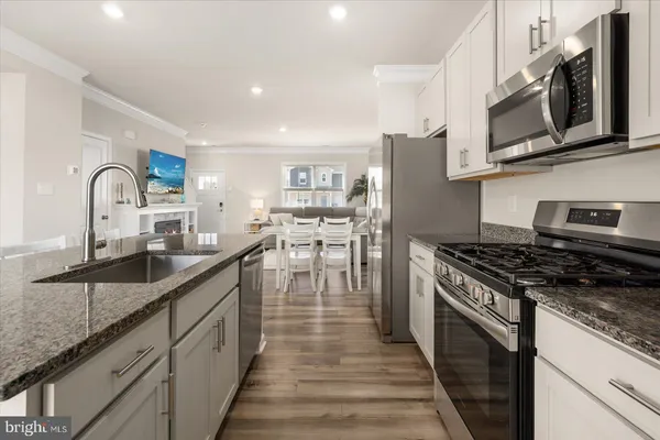 a kitchen with stainless steel appliances granite countertop a stove and a sink