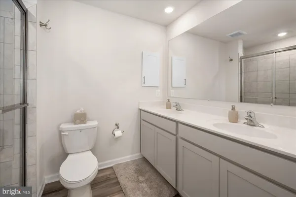 a bathroom with a glass shower door