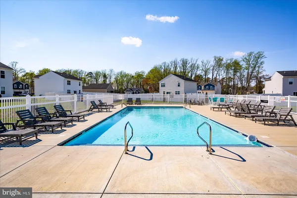 a front view of a house with swimming pool outdoor seating
