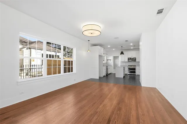 a view of a room with wooden floor and a window