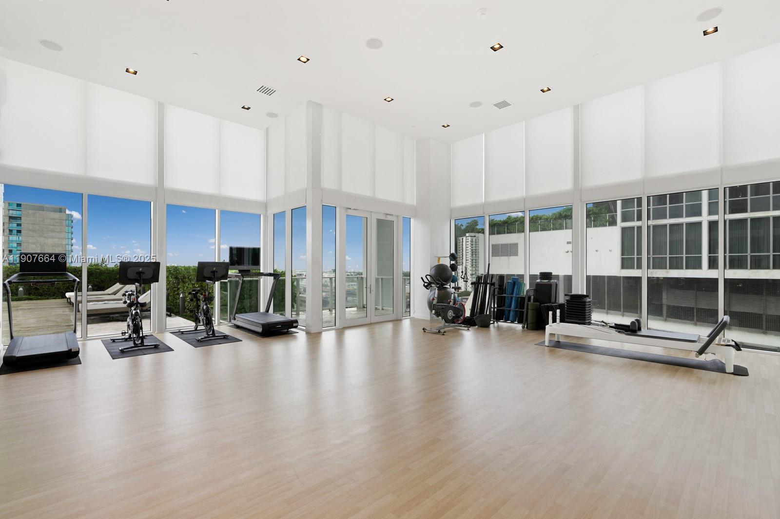1040 Biscayne Boulevard, Unit 2908 Miami, FL 33132 - Photo 11 of 14 a view of a living room with gym equipment