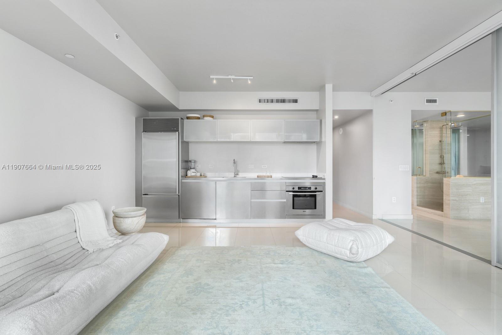 1040 Biscayne Boulevard, Unit 2908 Miami, FL 33132 - Photo 3 of 14 a living room with furniture and a couch