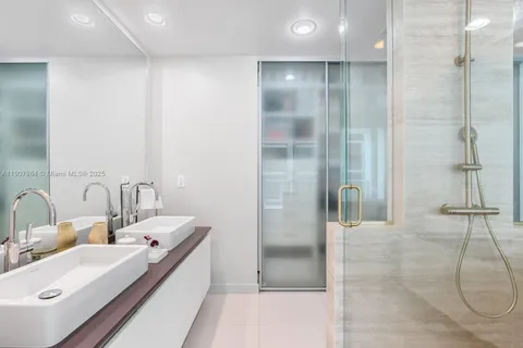 a bathroom with a double vanity sink and a mirror