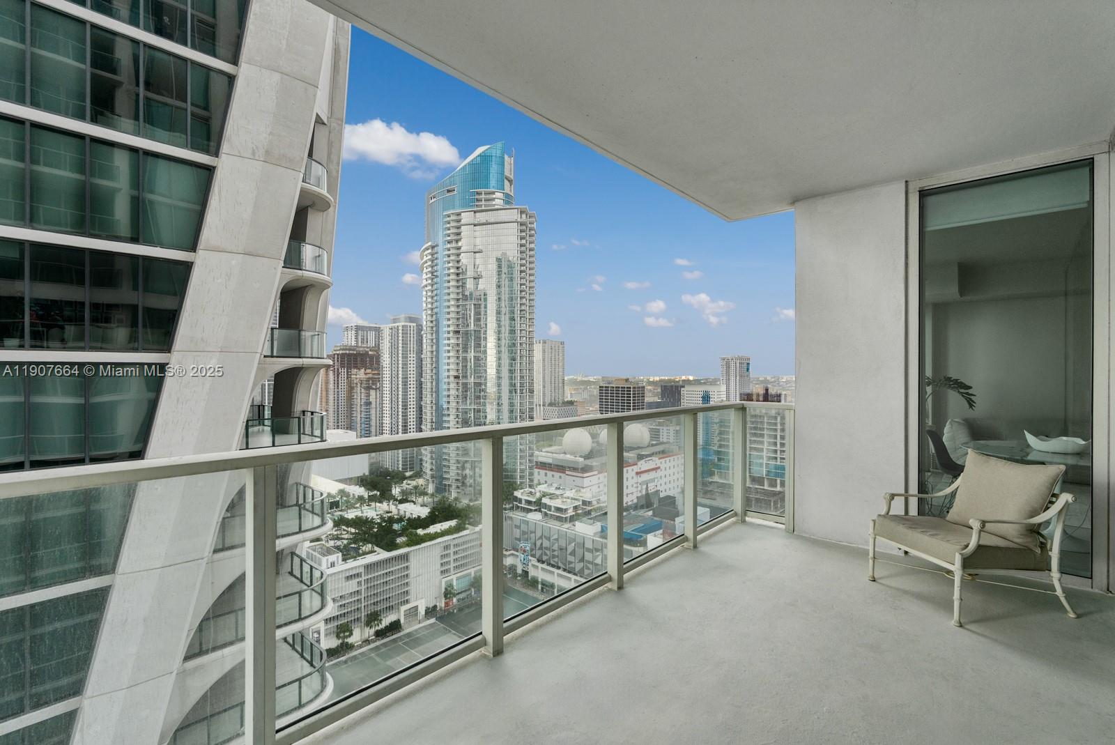 1040 Biscayne Boulevard, Unit 2908 Miami, FL 33132 - Photo 8 of 14 a view of balcony with book shelf