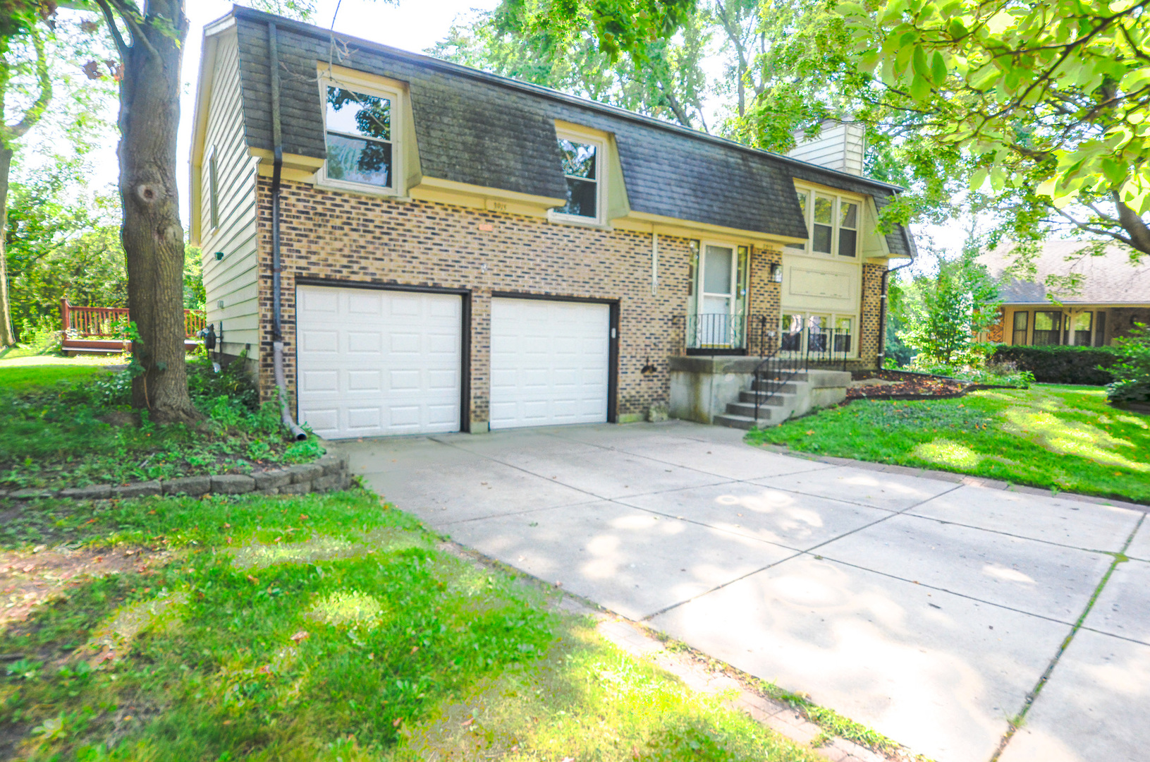 3915 Whispering Trails Drive Hoffman Estates, IL 60192 - Photo 1 of 12 a front view of a house with a yard and garage