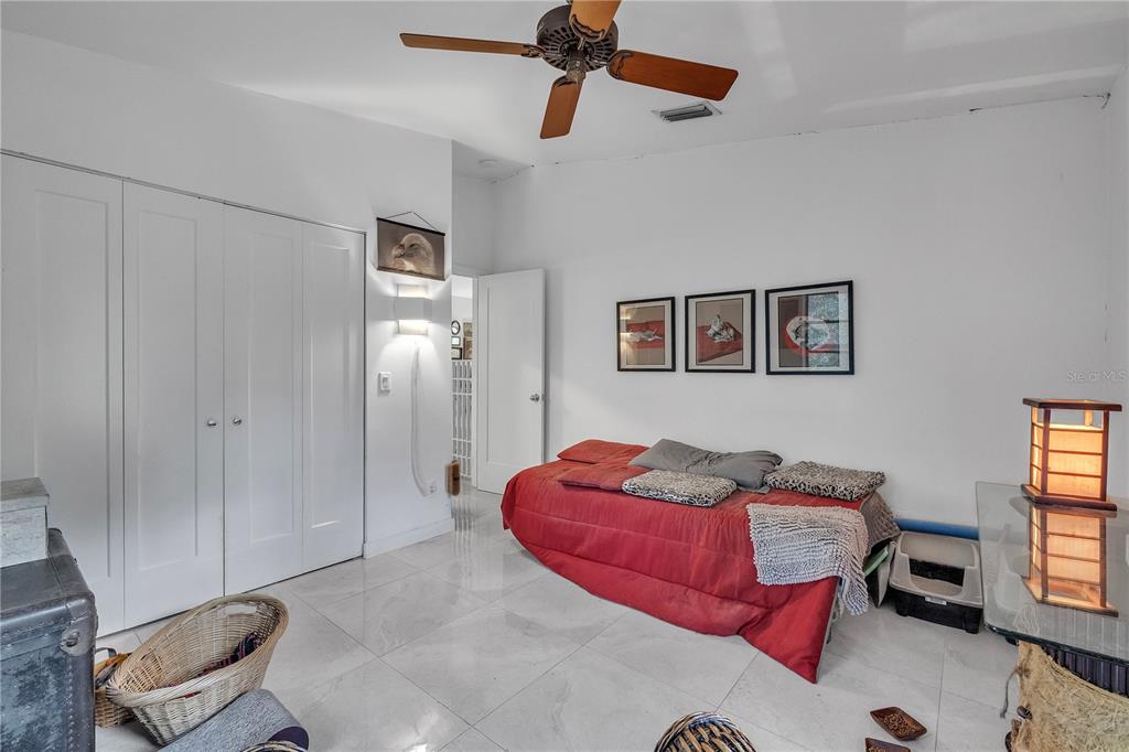 8056 Southwest Horse Creek Road Arcadia, FL 34266 - Photo 22 of 42 a bedroom with a bed and wooden floor