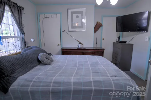 a bedroom with a large bed and a flat screen tv