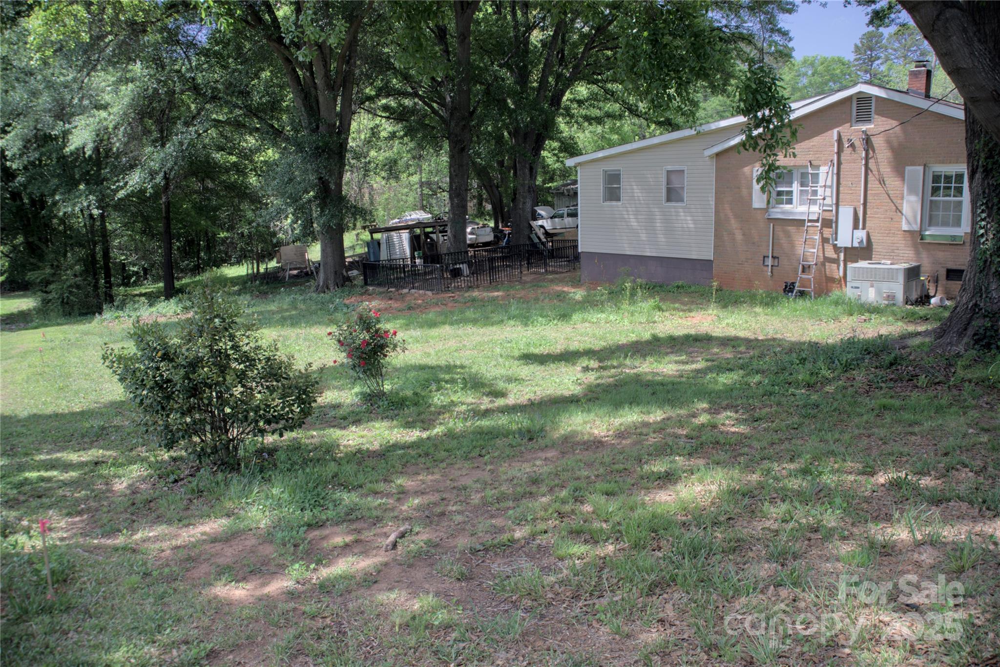 515 Upper Spencer Mountain Road Stanley, NC 28164 - Photo 23 of 24 a backyard of a house with table and chairs