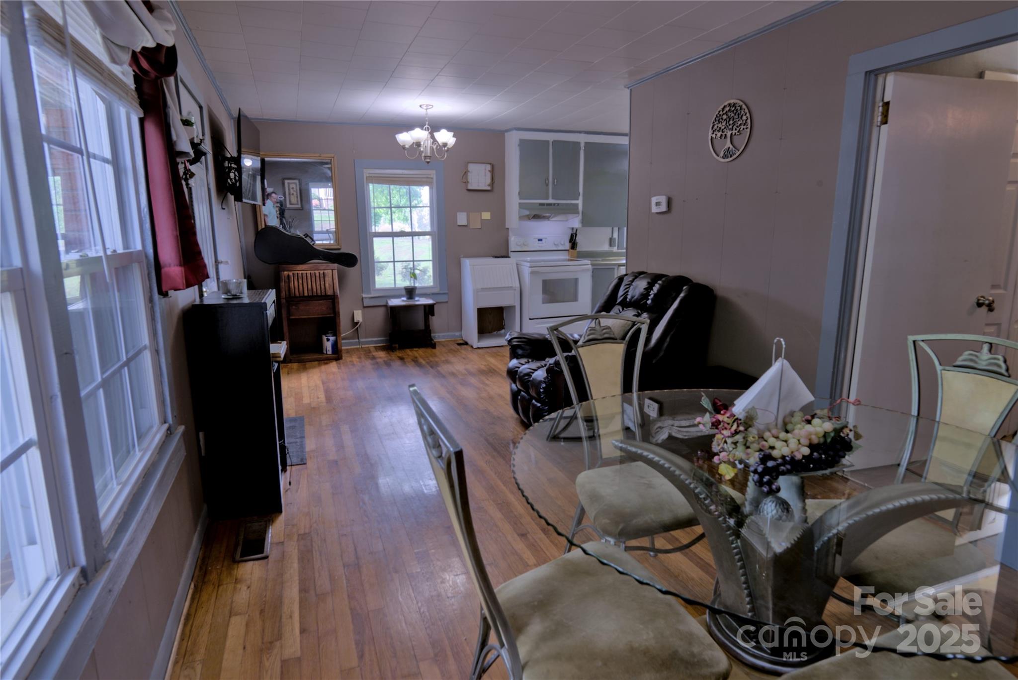 515 Upper Spencer Mountain Road Stanley, NC 28164 - Photo 5 of 24 a living room with furniture a flat screen tv and a window