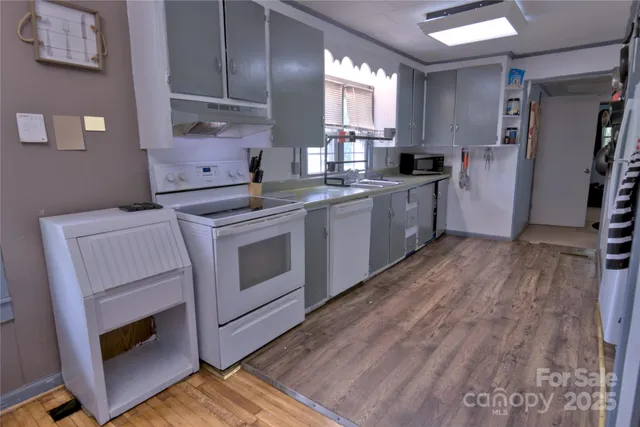 a kitchen with a stove a sink and a refrigerator